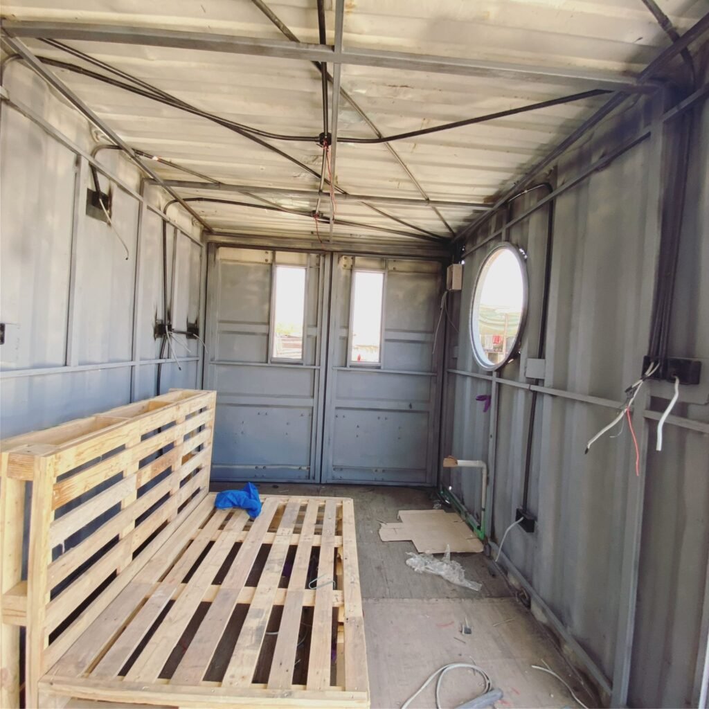 my shipping container, work in progress of my open-plan kitchen with wiring and steel reinforcements shown